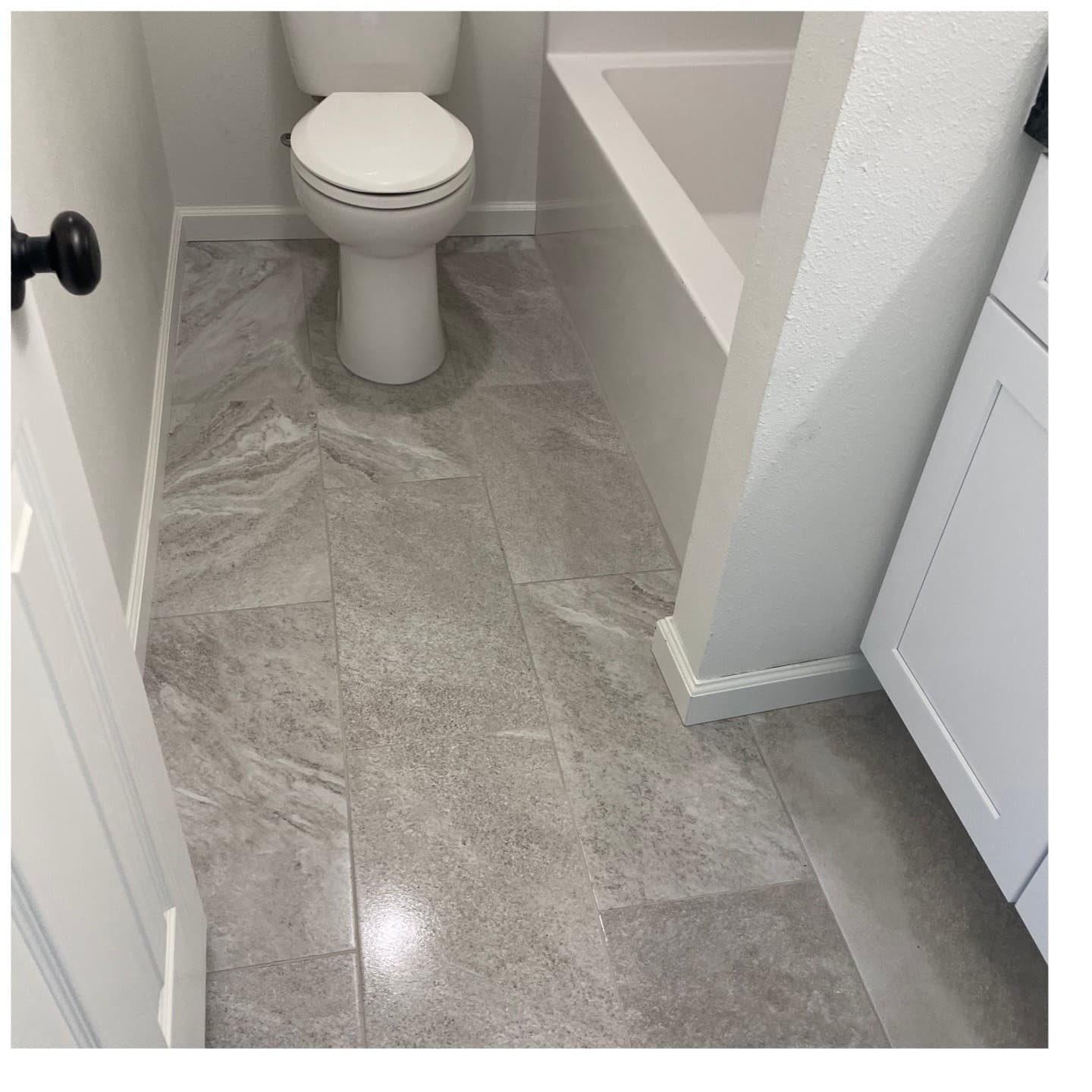 A finished bathroom floor and toilet area, cleaned after construction.