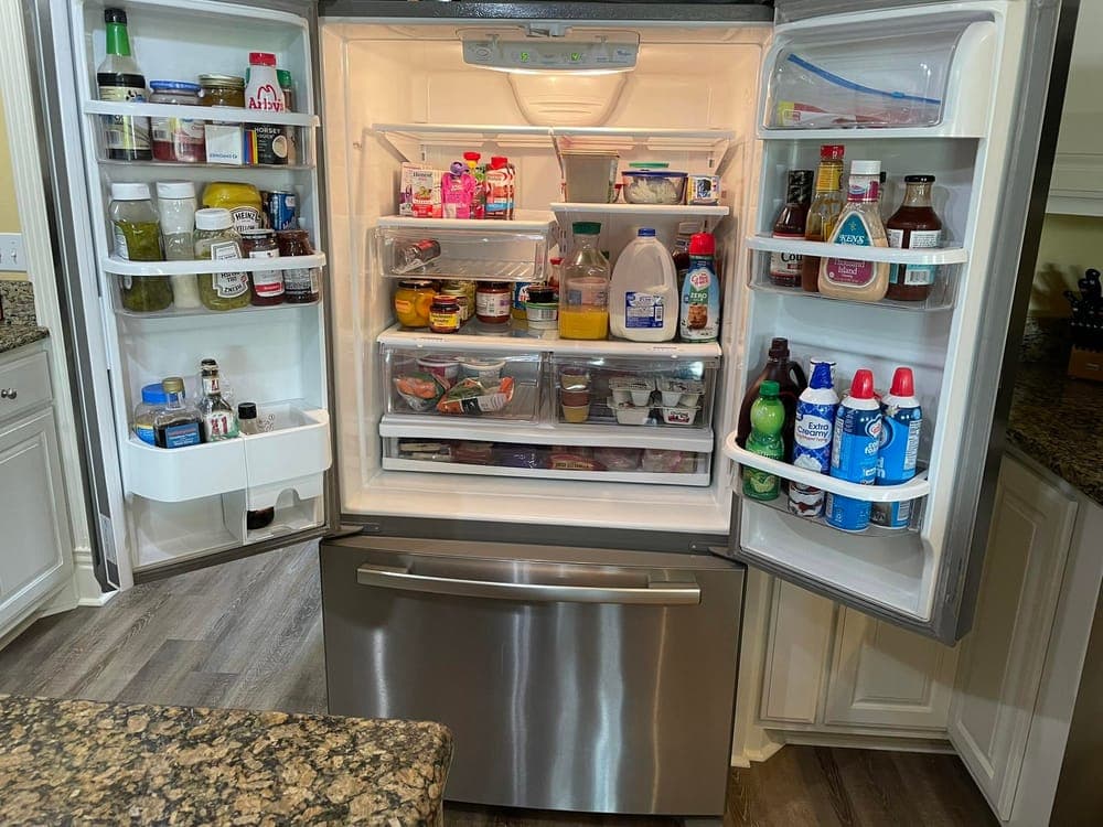 An open refrigerator, shelves cleaned and contents ordered.