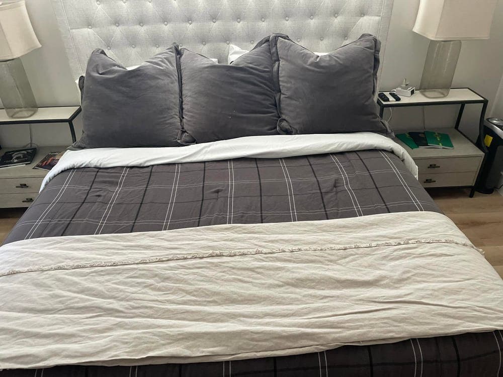 A bedroom with the bed remade and the room tidied.